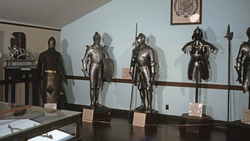 row of armor lined up along a wall