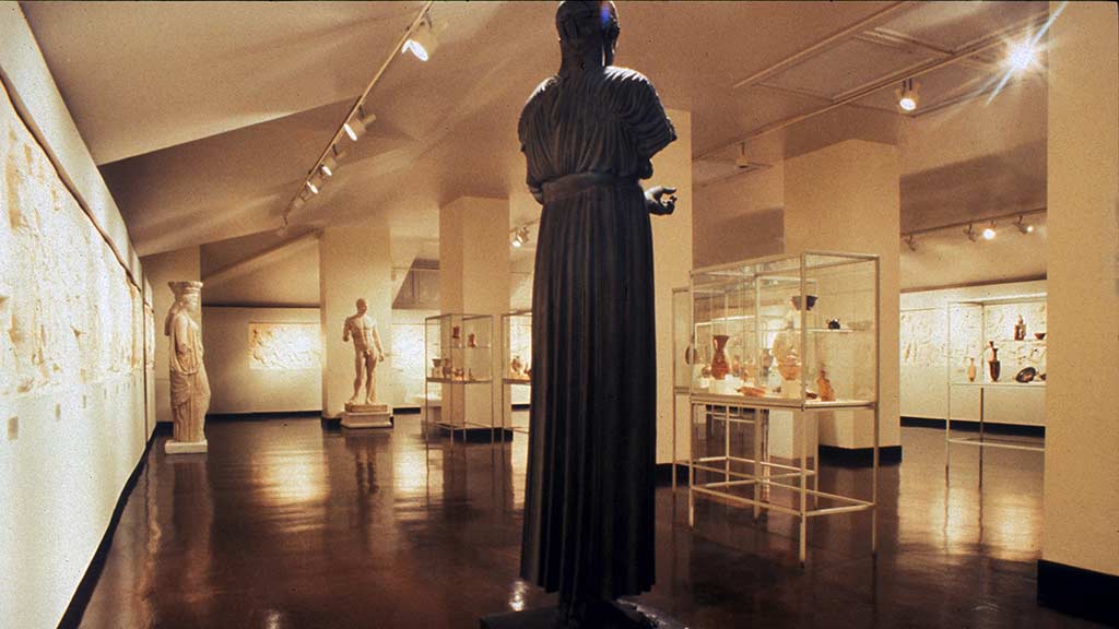 brightly lit gallery of statues and glass cases