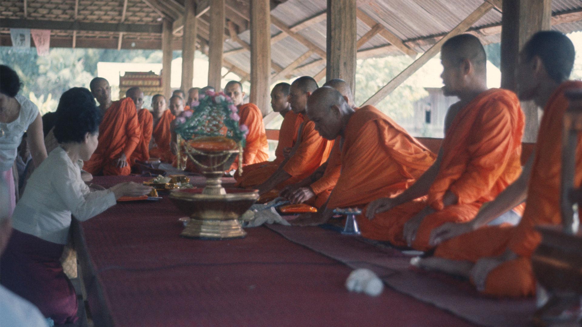 monks kneeling at a meal