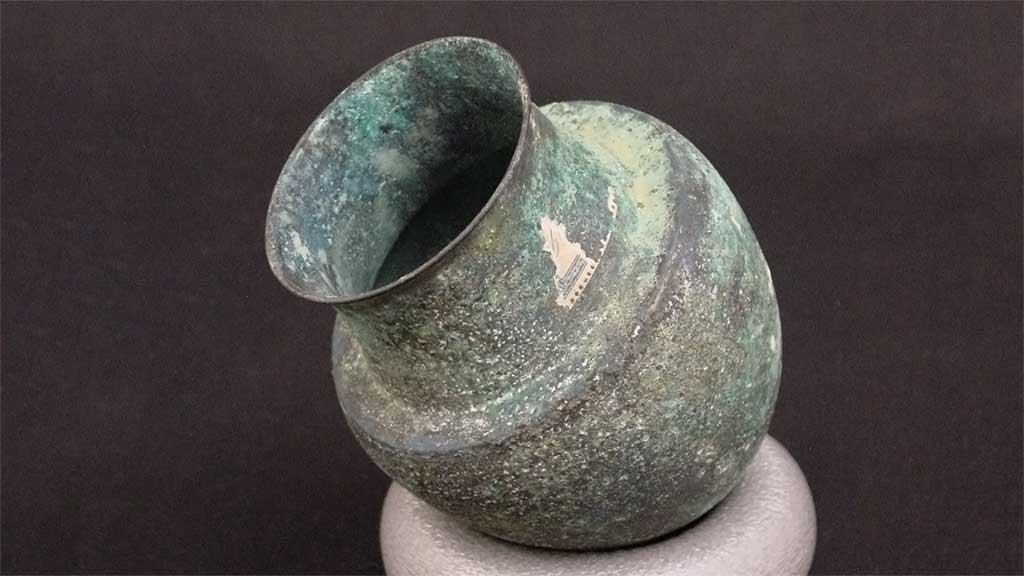 Bronze cup with a thin lip, abrupt shoulder, and a rounded base