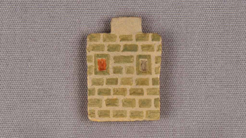 tiny depiction of a green bricked house wall