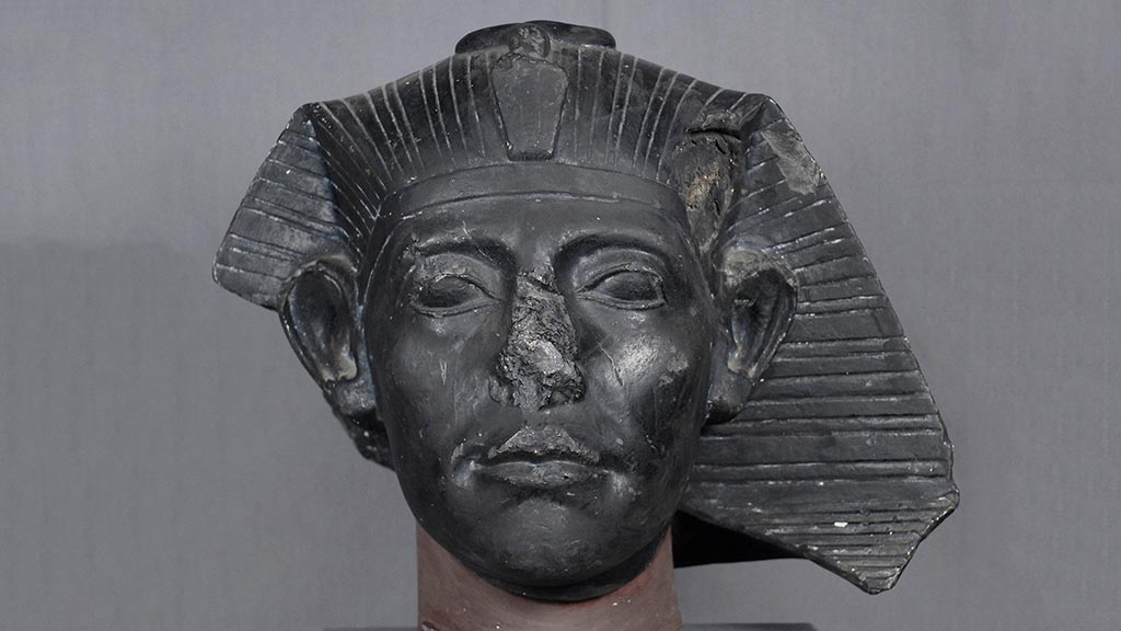 black-colored bust of a pharoah's face