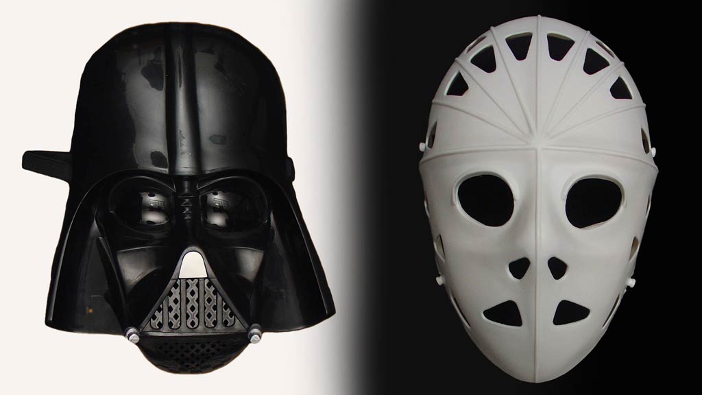 Black Darth Vader Star Wars mask next to a white field hockey mask