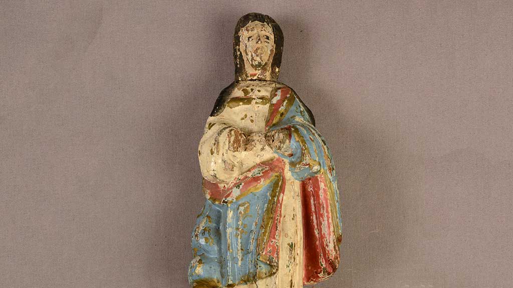 painted metal figurine of a robed man