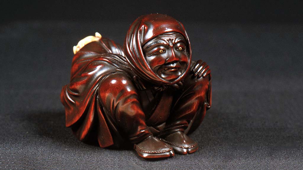 carved crouching figure
