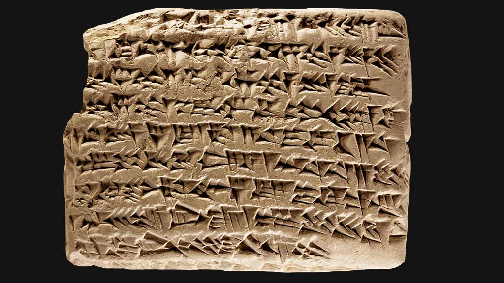 second rectangular tablet with densely packed cuneiform covering the surface