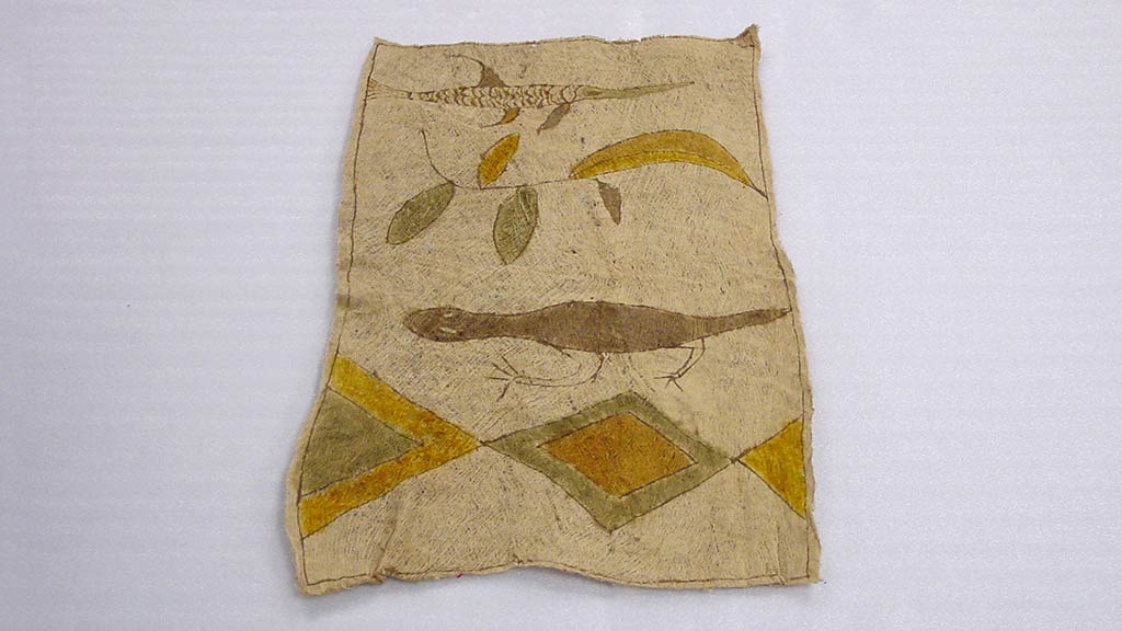 rectangular bark cloth with green, brown, and gold design