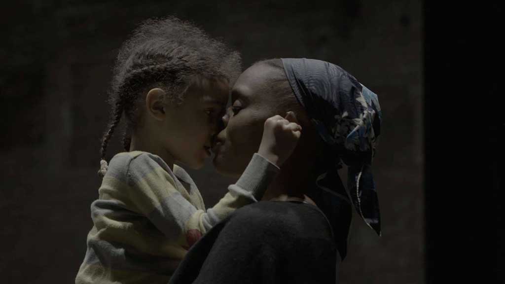 still from the film of a woman holding a girl