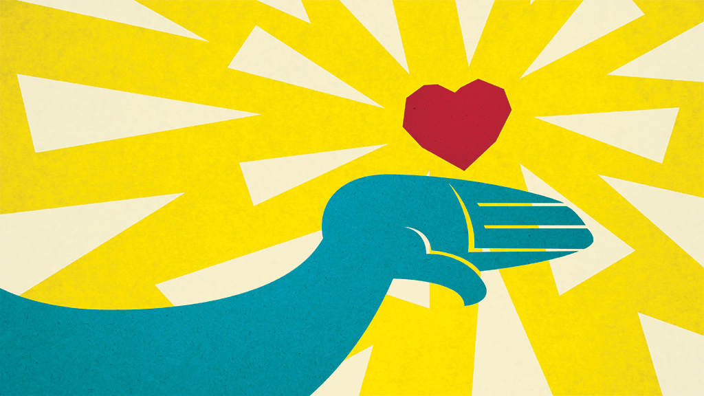 a hand holding a heart in yellow background