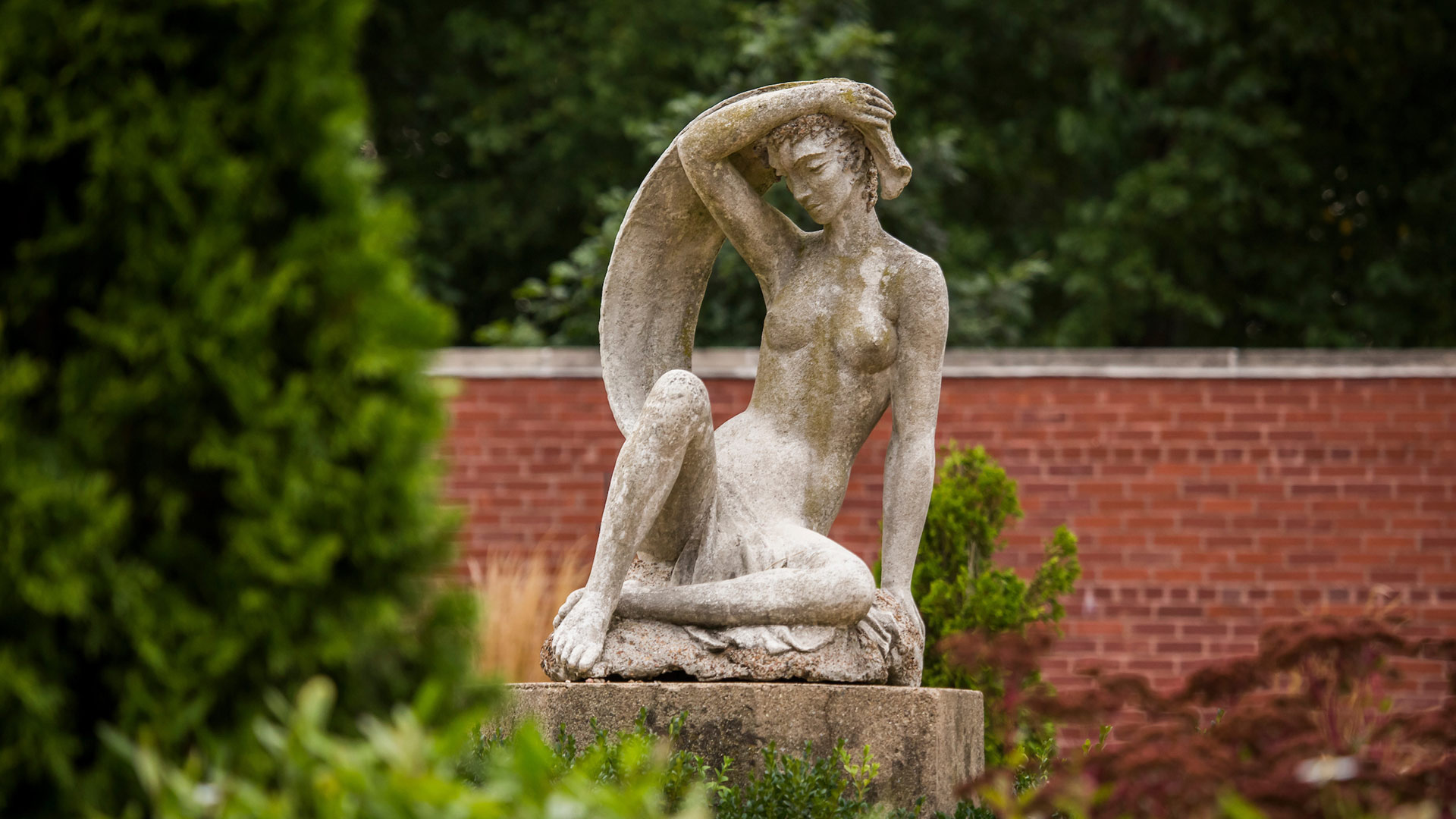 Statue of woman in garden