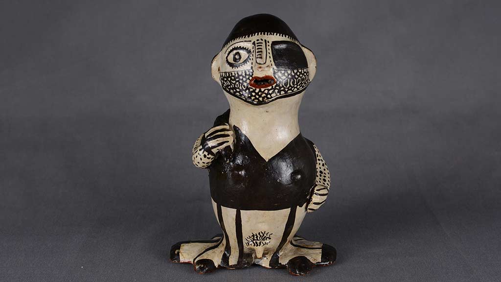 black and white ceramic figure with beard stubble and an eye patch