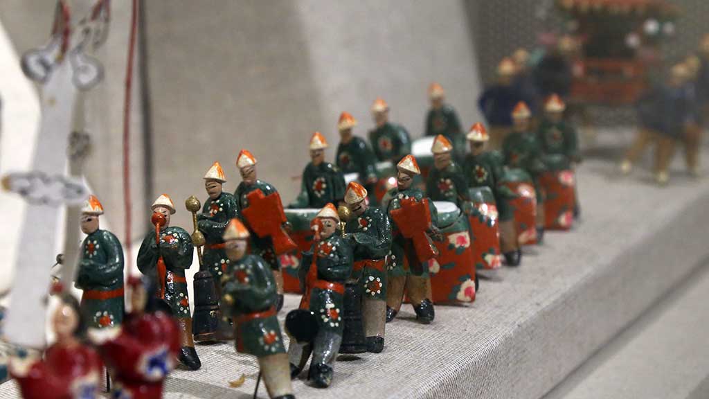 many small ceramic figures in a procession