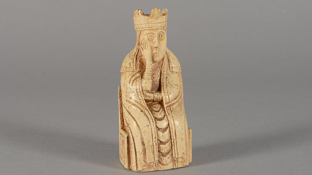 Cream-colored chess piece. A king holds his face wearily.
