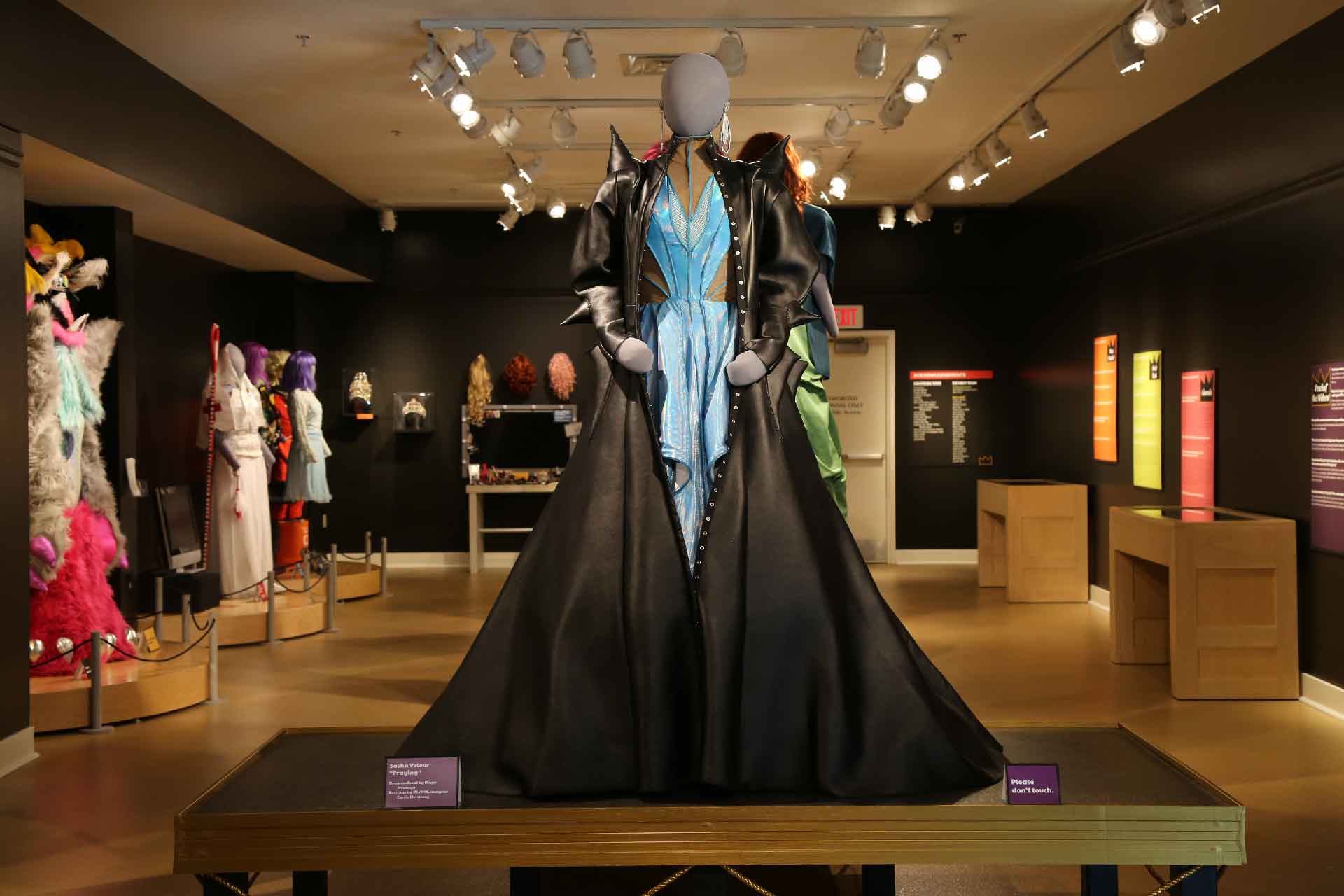 front view of gallery featuring mannequin in light blue and black costume