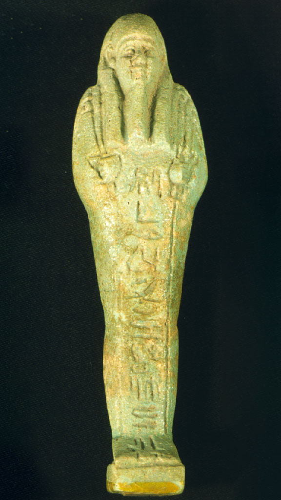 greenish stone carving of a mummified human with hieroglyphics