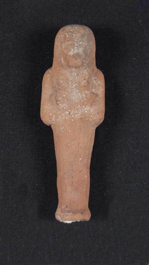 reddish stone carving of a mummified human