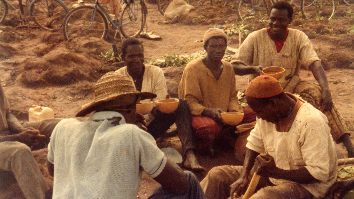 a group of men sitting around and talking