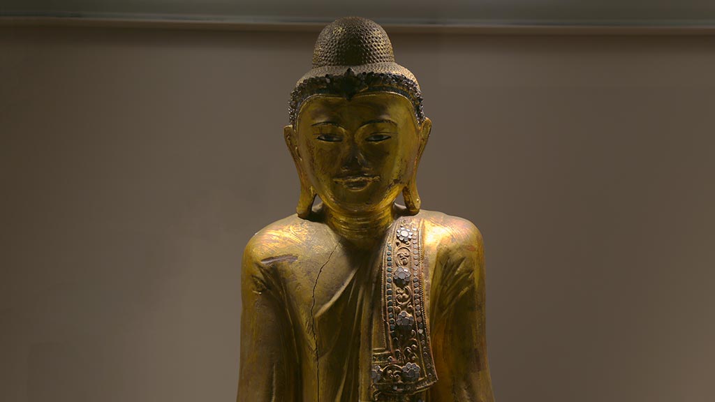 head and shoulders of a golden Buddha figure
