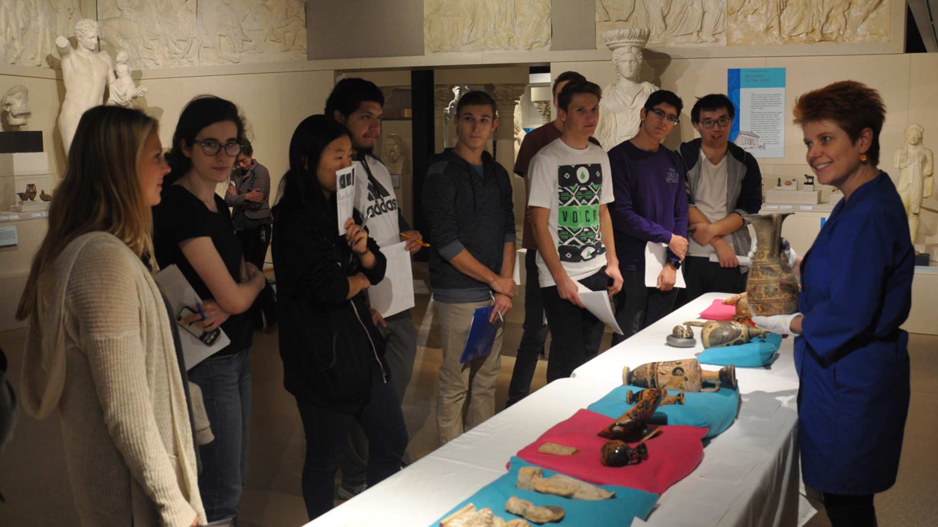 students in Ancient Med gallery reviewing objects led by a facilitator
