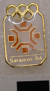 Thumbnail of Olympic Commemorative Pin:  Orange and White Snowflake Emblem Sarajevo 1984 (1984.18.0018)