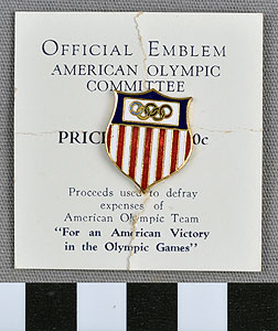 Thumbnail of Commemorative Olympic Pin: Official Emblem American Olympic Committee, Mounted on white paper stock (1977.01.1009Z)