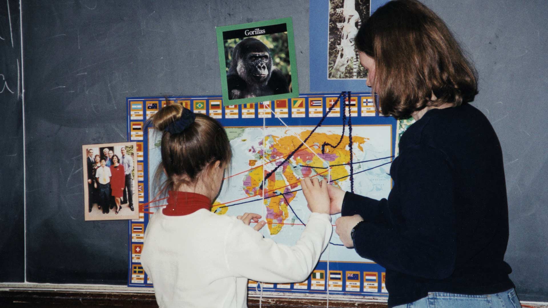 a young woman helping a little girl connecting pictures