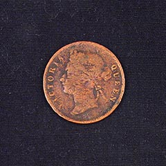 copper tinted coin with a woman whose hair is tied facing to the left.  Victoria Queen is printed looping around the edges
