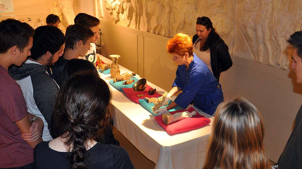 Post Photo: students in gallery with artifacts