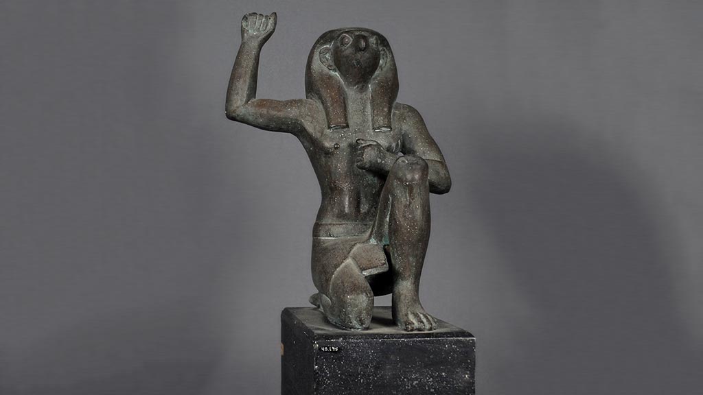 figure of kneeling god raising hand and looking toward the sky