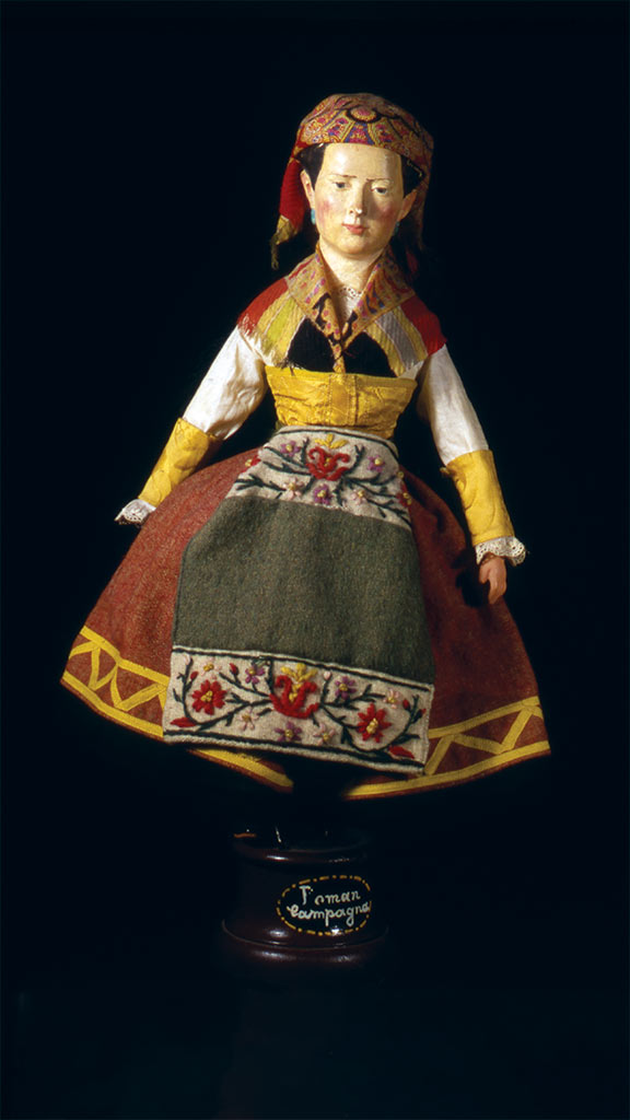 female doll wearing a yellow,red, and white dress