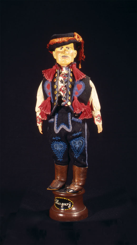 male doll wearing black,blue and red outfit