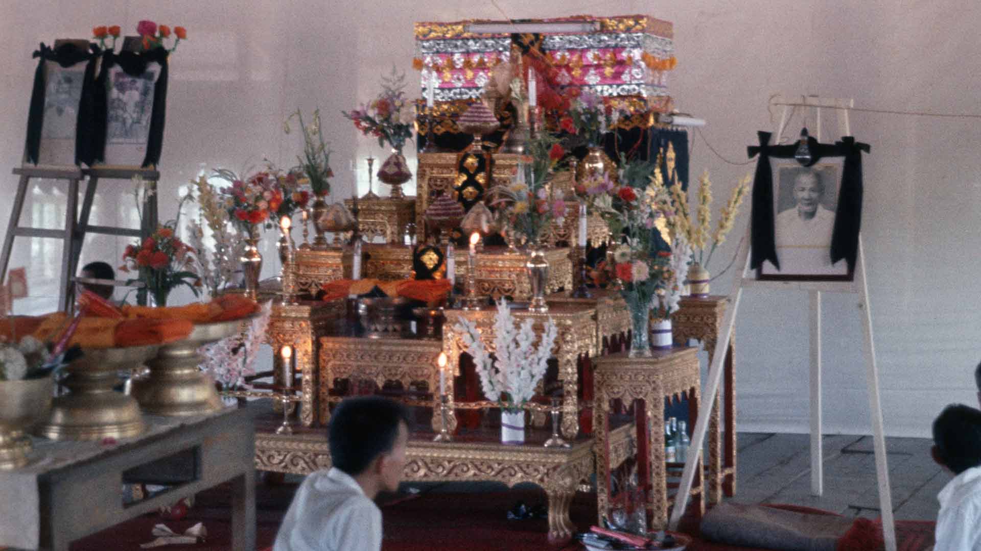 A shrine with offerings including photo of deceased
