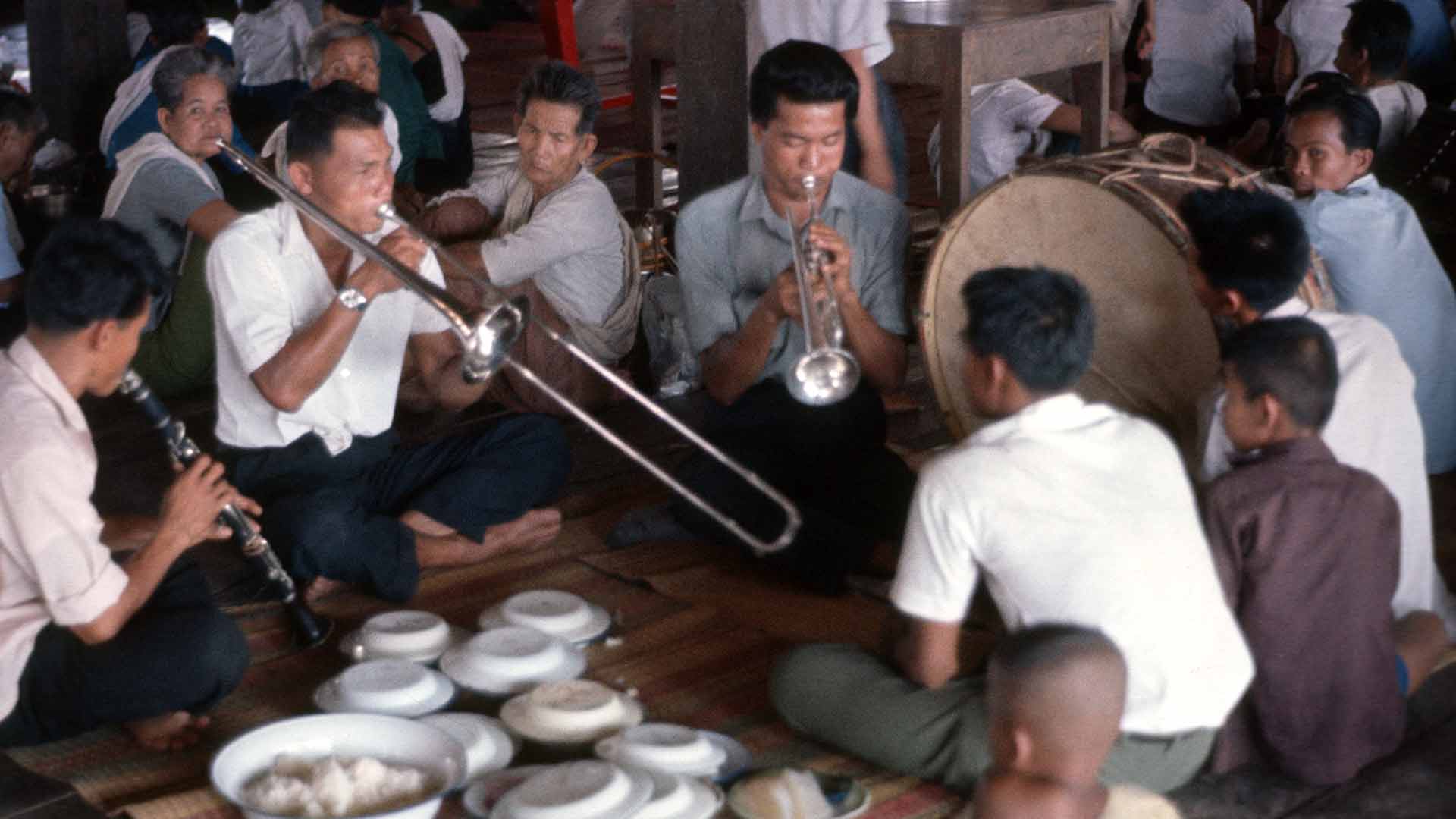 musicians seated playing music