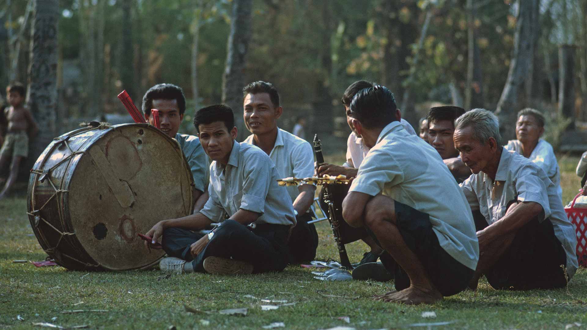 male villagers with various instruments for ceremony