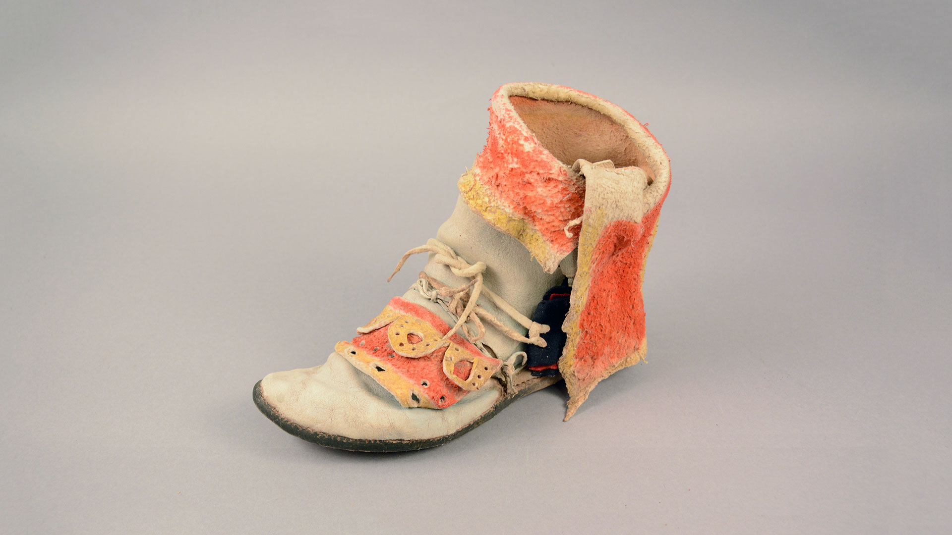 cream colored boot with orange and yellow animal hide accents