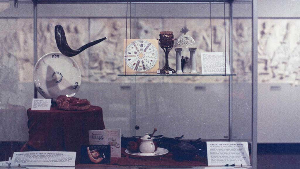 Display case featuring several artifcats, including plates and small containers