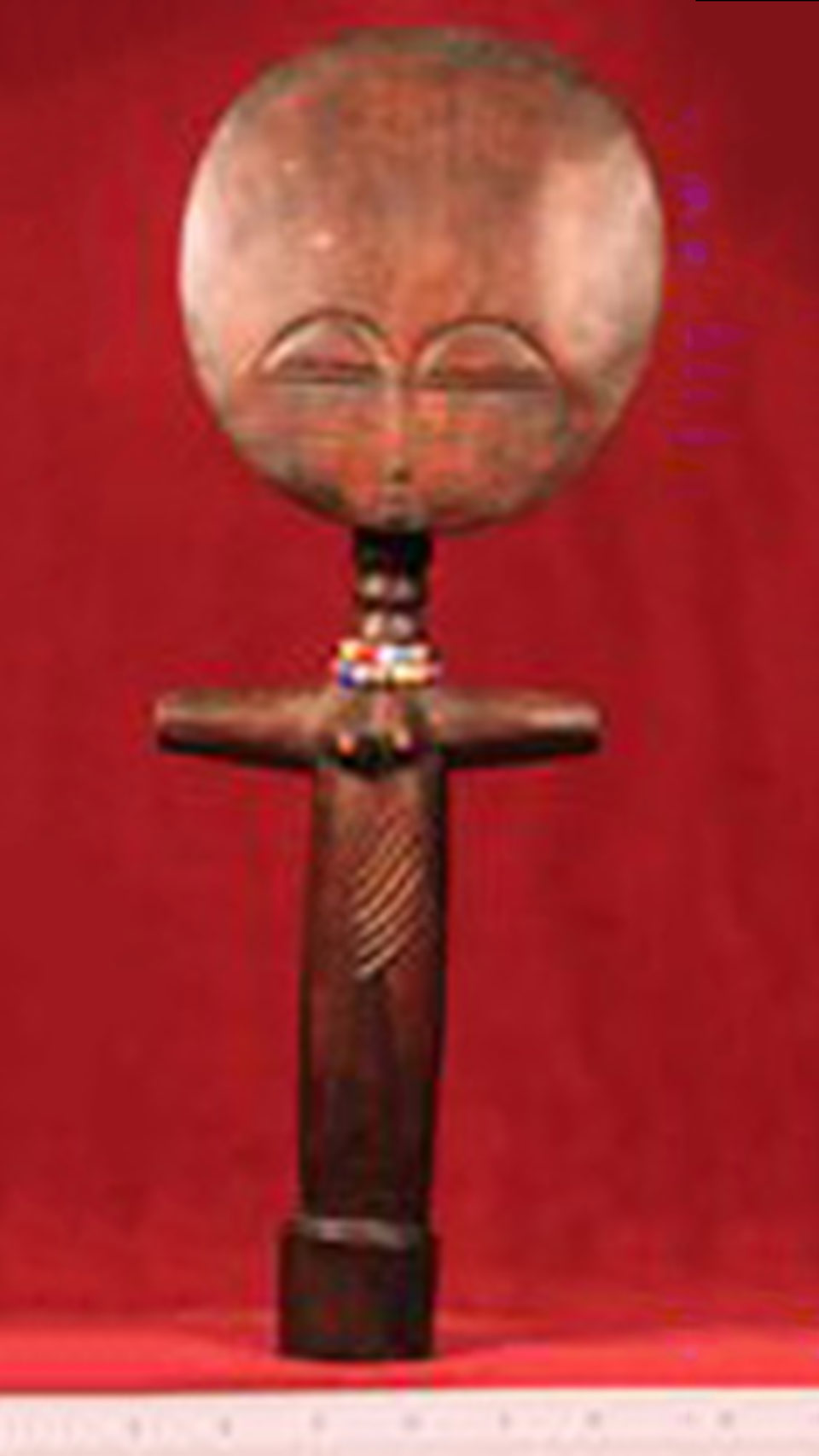 blurred image of a wooden African doll