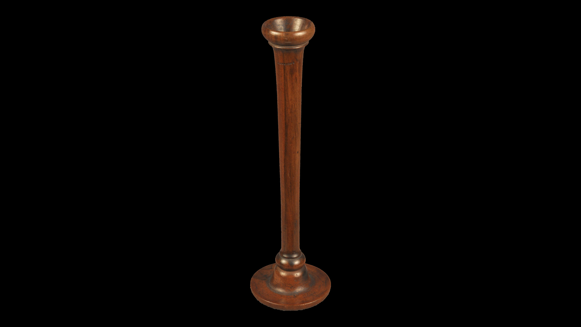 wooden upright device with a smaller circular opening at the top and a bigger circular base