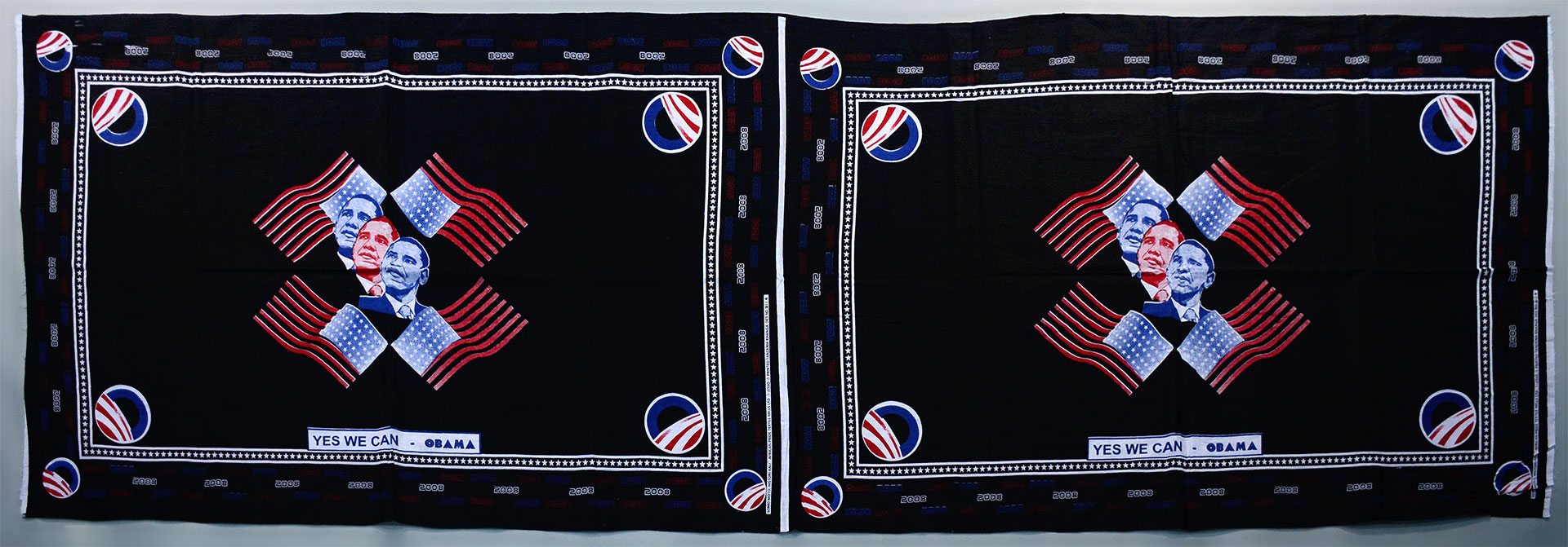 Two panel black fabric with Obama images, american flag, and campaign logo printed in red white and blue