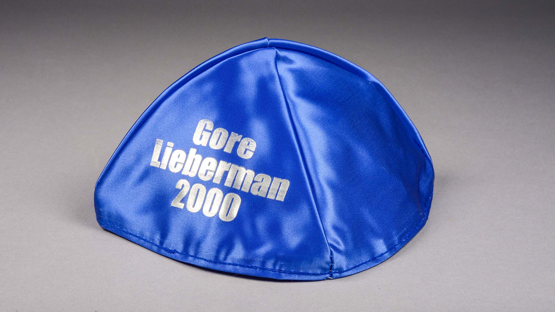 blue satin yarmulke with Gore Lieberman 2000 text printed in white