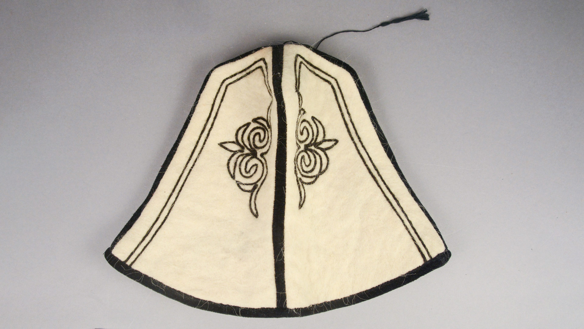 white bell-shaped hat with black embroidery