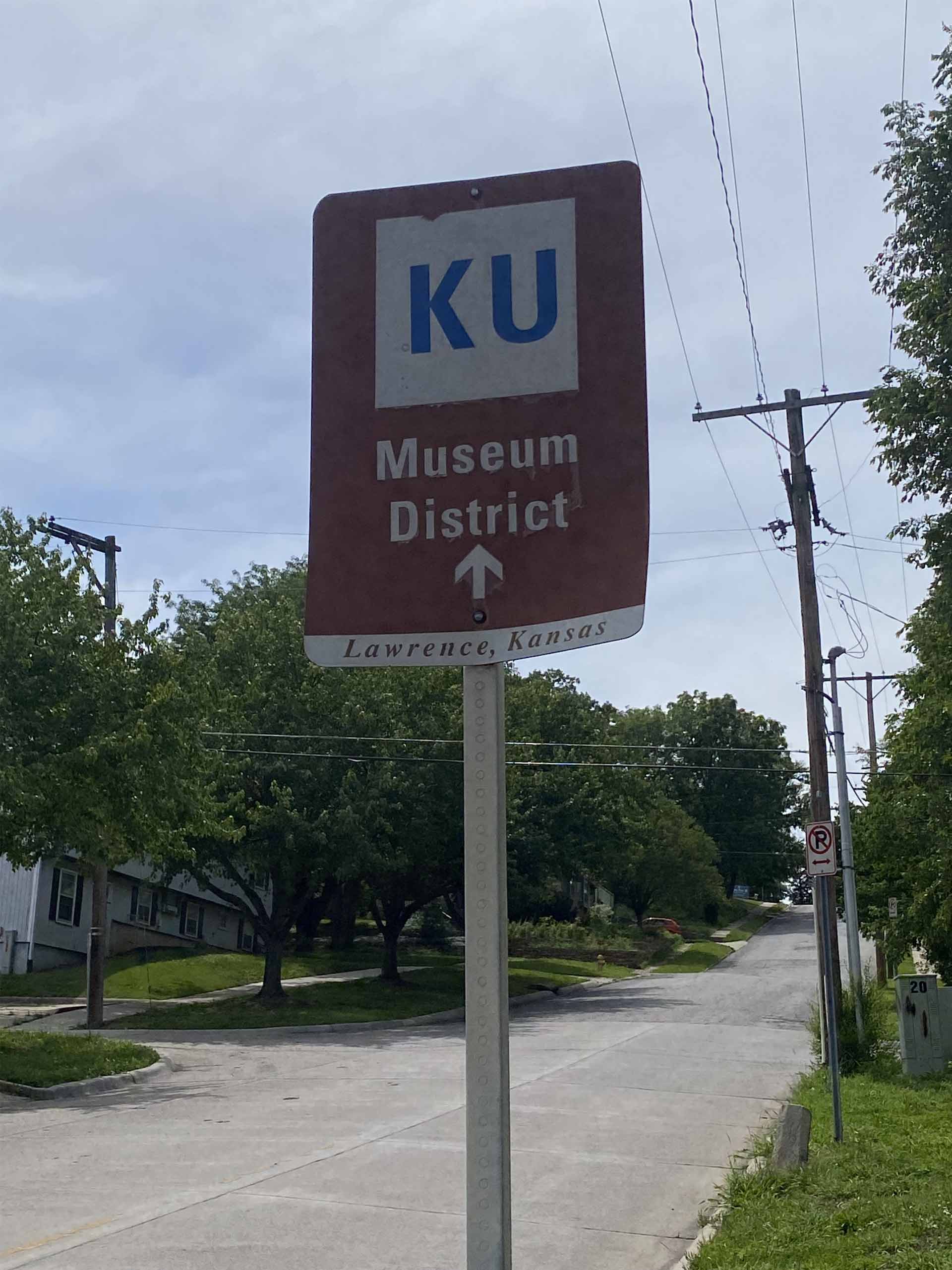 street sign that says, 'KU, Museum District, Lawrence, Kansas'