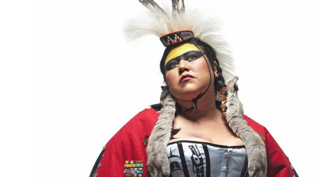 Native American woman posing and looking to the left on a white background