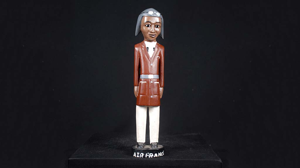carved wooden figure of a pilot with red coat
