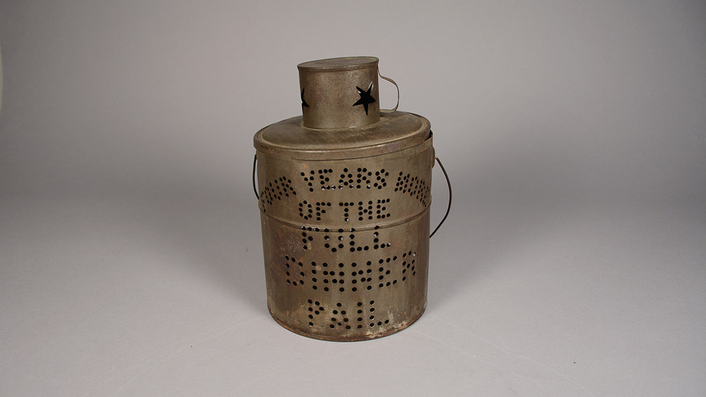 A rusty campaign torch with the words 'Four Years More of the Full Dinner Pail'