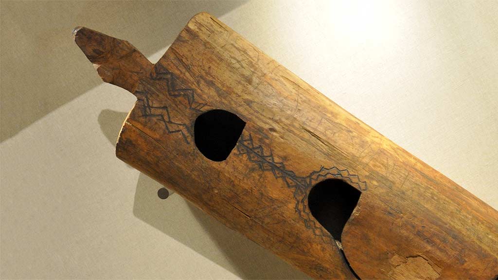 large hollow wooden instrument with two holes