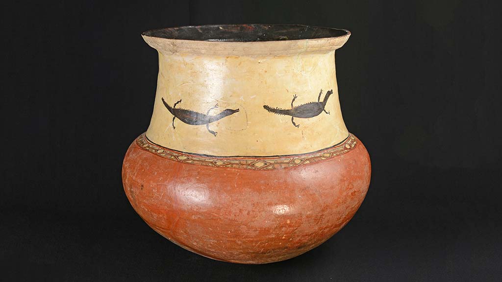 large red and yellow vessel with painted lizard-like animals 