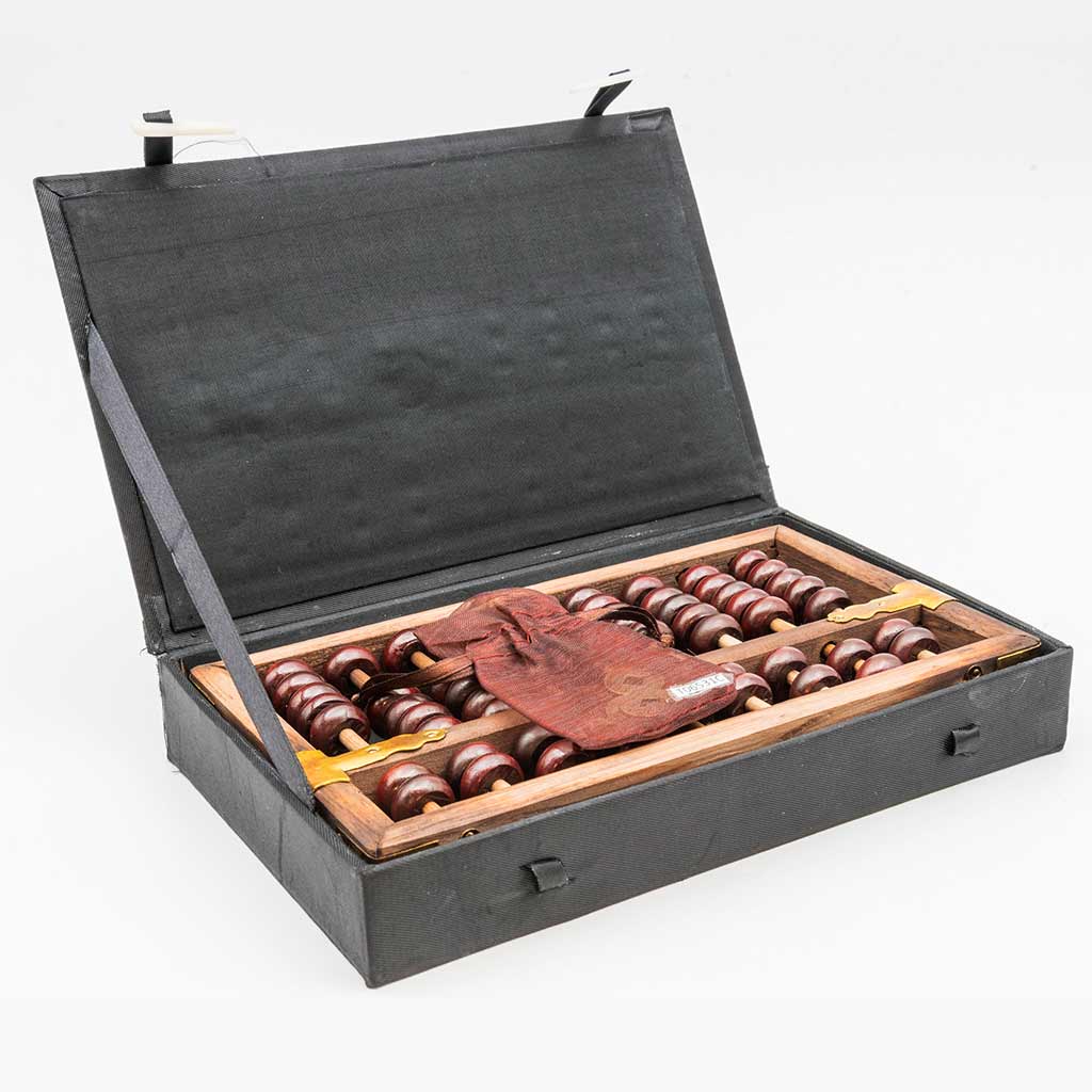 a black box with a brown abacus and a bag of coins