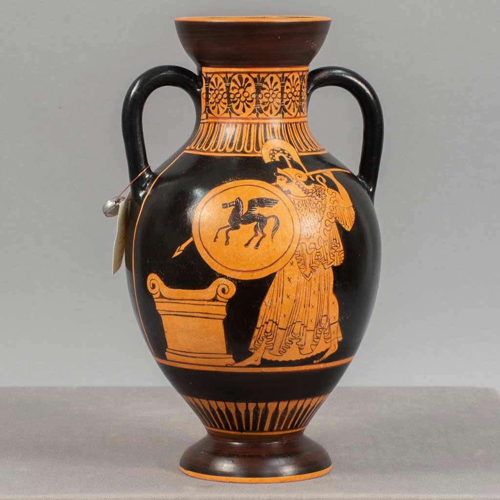 A brown and orange vase with handles depciting a woman holding a shield with a silhouette of a horse with wings