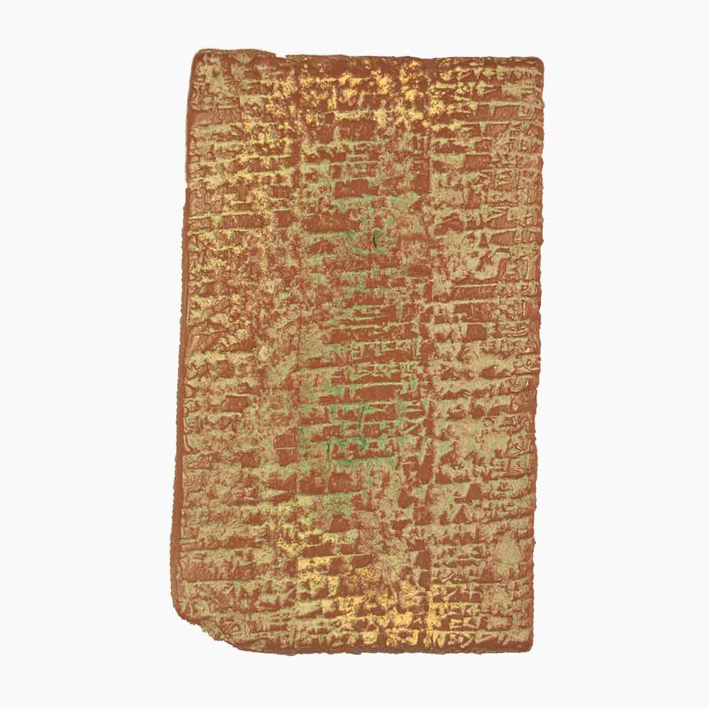 An aged brown, yellow, and green rectangular tablet on a white background